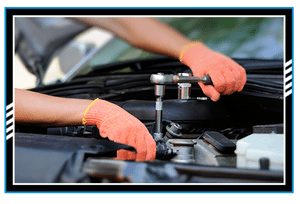 Hands of car mechanic in auto repair service