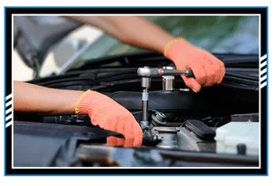 Hands of car mechanic in auto repair service