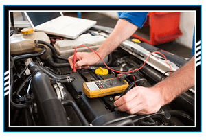 Mechanic using diagnostic tool on engine at the repair garage